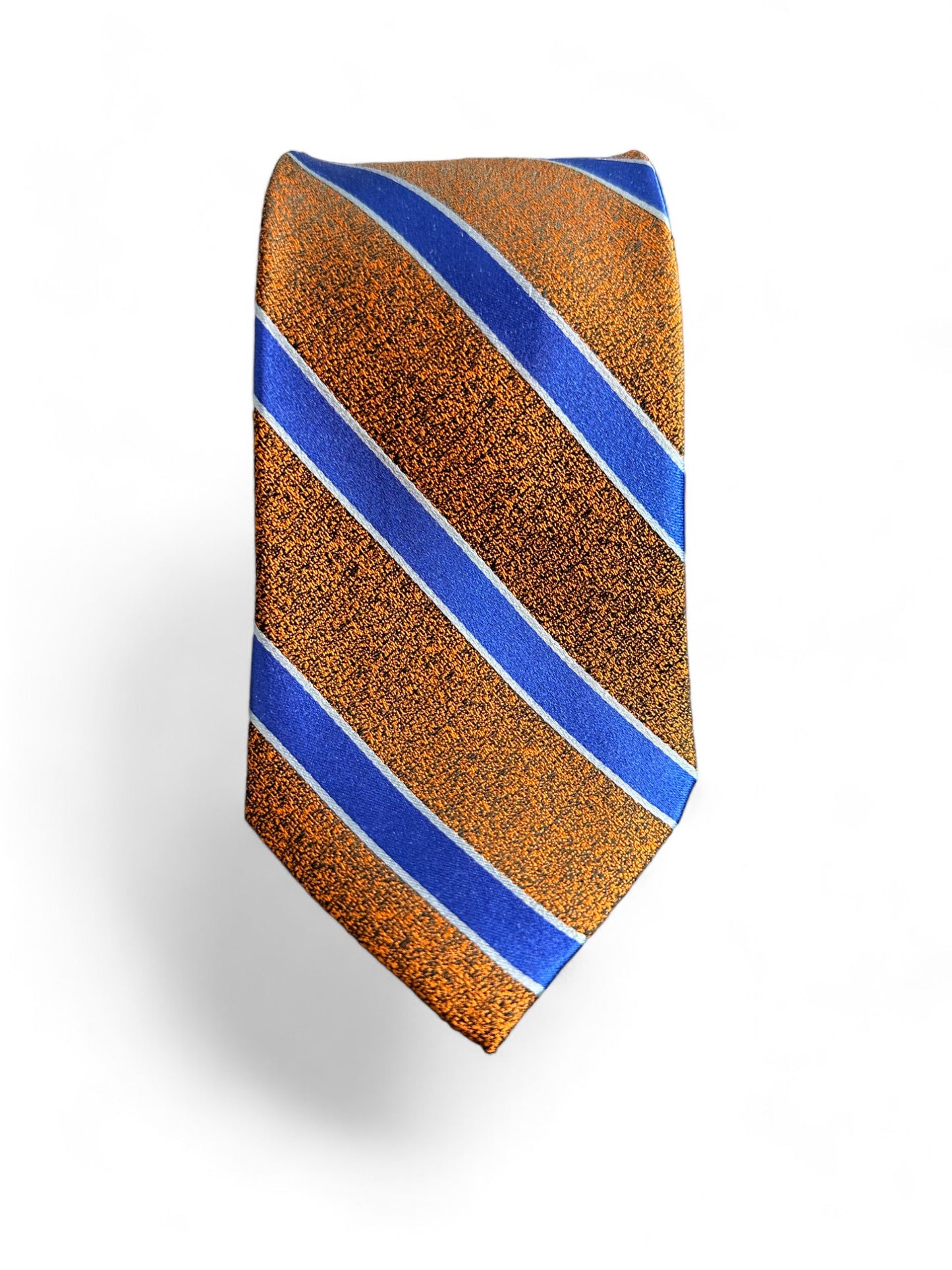 Elevate your style with our SUITCAFE Woven Silk Burnt Orange & Cobalt Blue Tie. Handmade from 100% pure, luxurious silk, this stunning necktie features bold burnt orange and cobalt blue stripes, adding a touch of sophistication to any outfit. An elegant tie to take you from summer into fall.