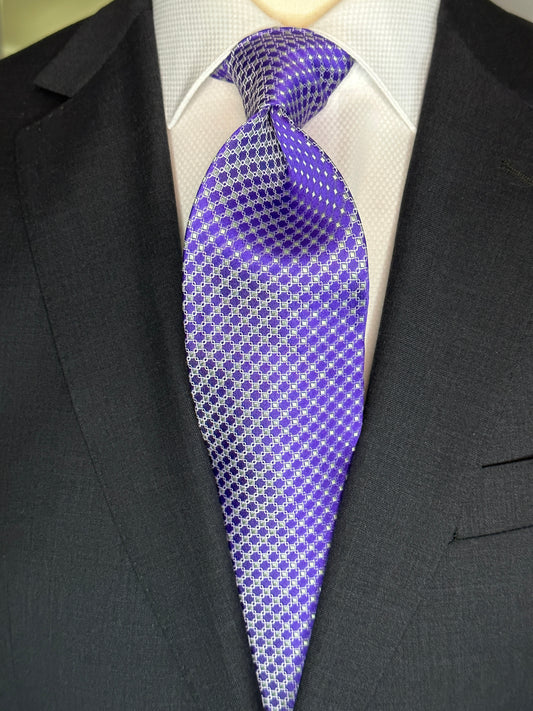 This 100% silk necktie is made from the finest Italian woven silk. The pattern is a small neat geometric making for a cool, crisp look. Inside each small checkered square is a small pale green square. This is a very sophisticated tie for business, dinners or even a wedding.