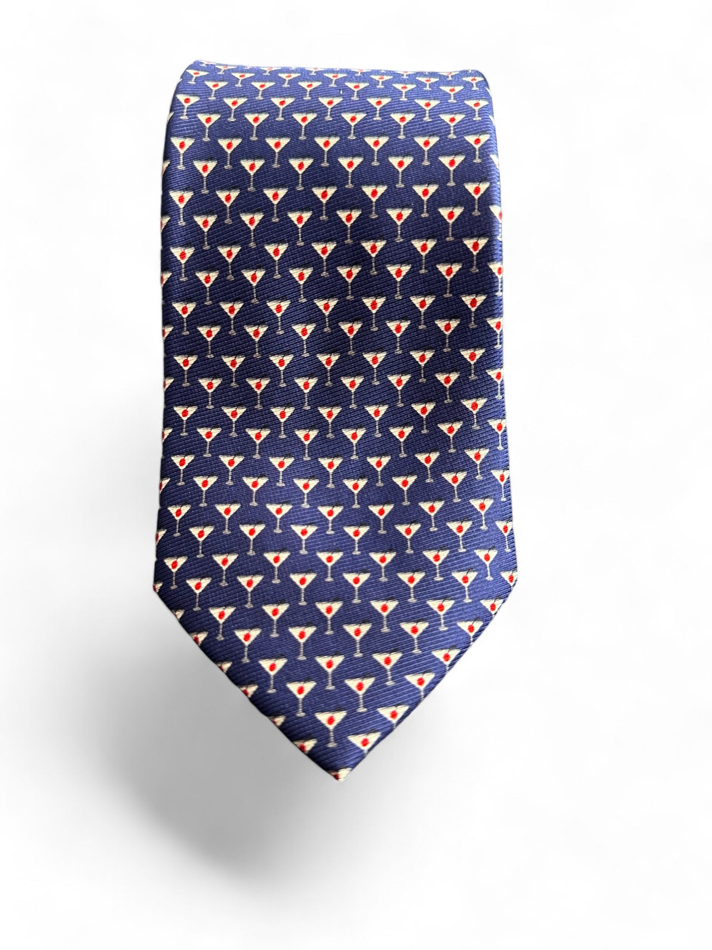 Expertly crafted from luxurious navy silk twill, this tie from SUITCAFE features a playful martini glass geometric pattern with an olive on top. Elevate any outfit with this sophisticated and unique accessory. Perfect for adding a touch of personality and class to any formal or professional look.