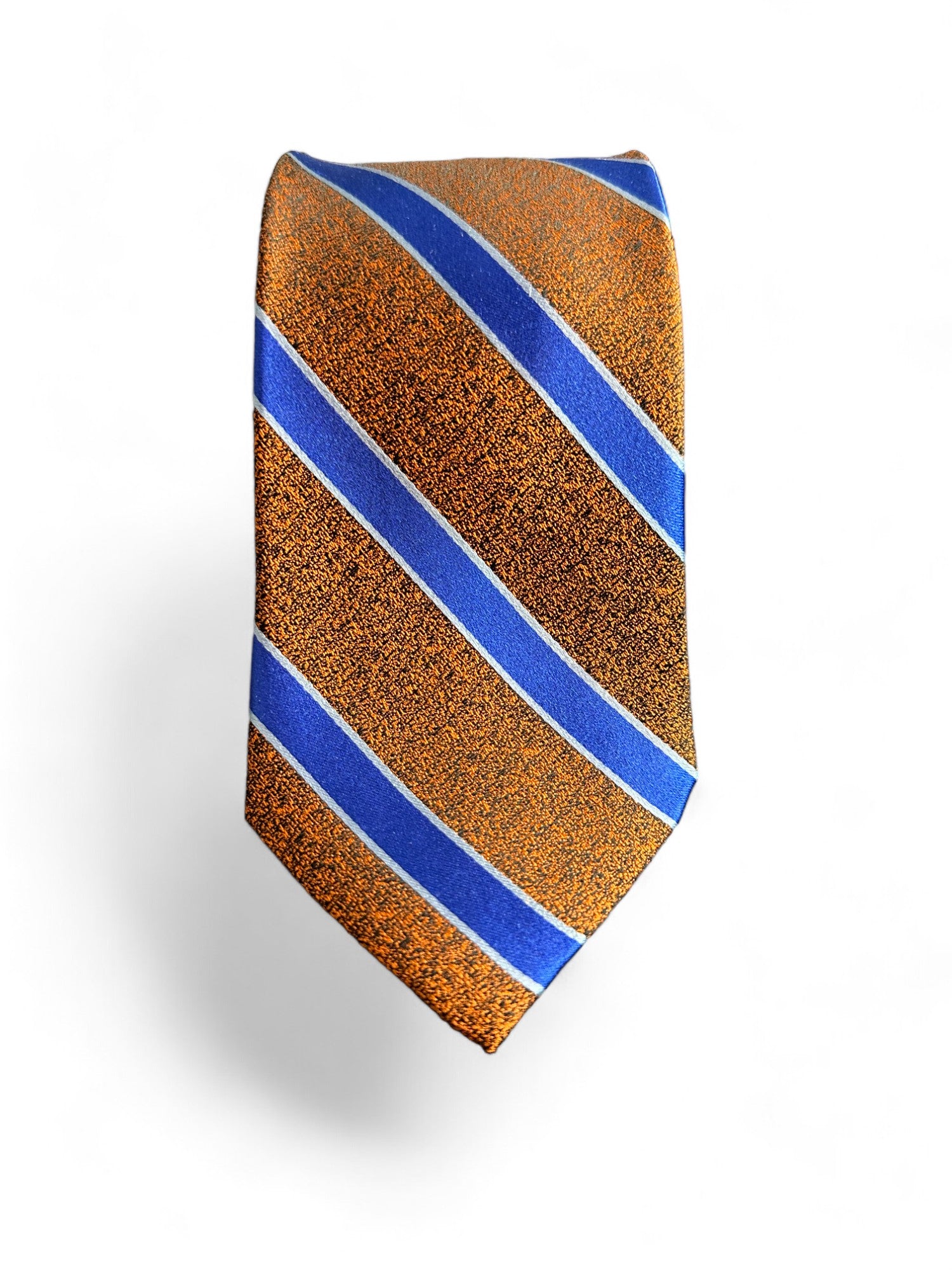 Elevate your style with our SUITCAFE Woven Silk Burnt Orange &amp; Cobalt Blue Tie. Handmade from 100% pure, luxurious silk, this stunning necktie features bold burnt orange and cobalt blue stripes, adding a touch of sophistication to any outfit. An elegant tie to take you from summer into fall.
