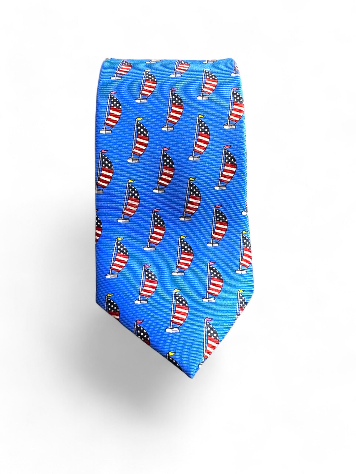 Elevate your look with the SUITCAFE Patriot USA Flag Sailing Tie. Crafted from 100% handmade silk, this royal blue tie features a subtle geometric design and an elegant patriot USA flag motif on a sailboat. Perfect for any occasion, it's a true representative of luxury and style.