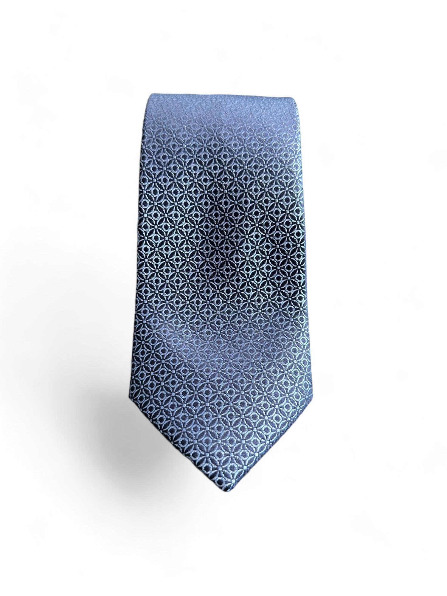 Add a touch of sophistication and modern style to your wardrobe with the SUITCAFE Steel Blue Woven Silk Tie. Handmade with high-quality woven silk, this tie features a unique geometric pattern that will elevate any outfit. With its steel blue color, it is the perfect complement to your professional or formal attire.