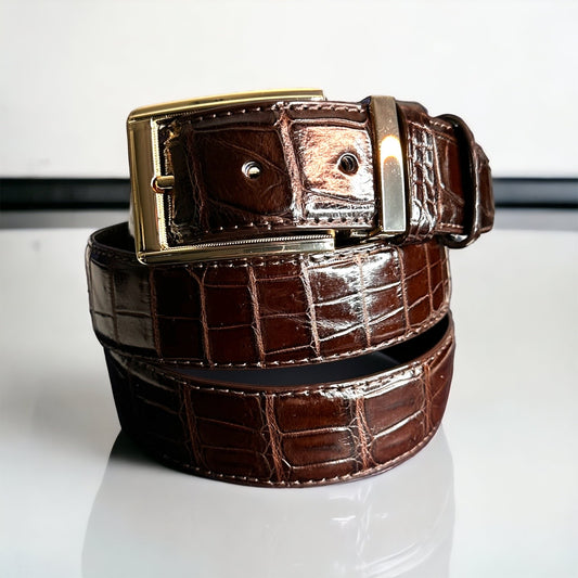 This handmade dark brown natural skin belt in crocodile serves as the standard for men's belts for suits. What is so great about this type of skin is that it fits with any outfit even jeans. With the supplied gold square and nickel square buckles, you get to choose what look you need for any type of event. Adjustable. Interchangeable buckles.
