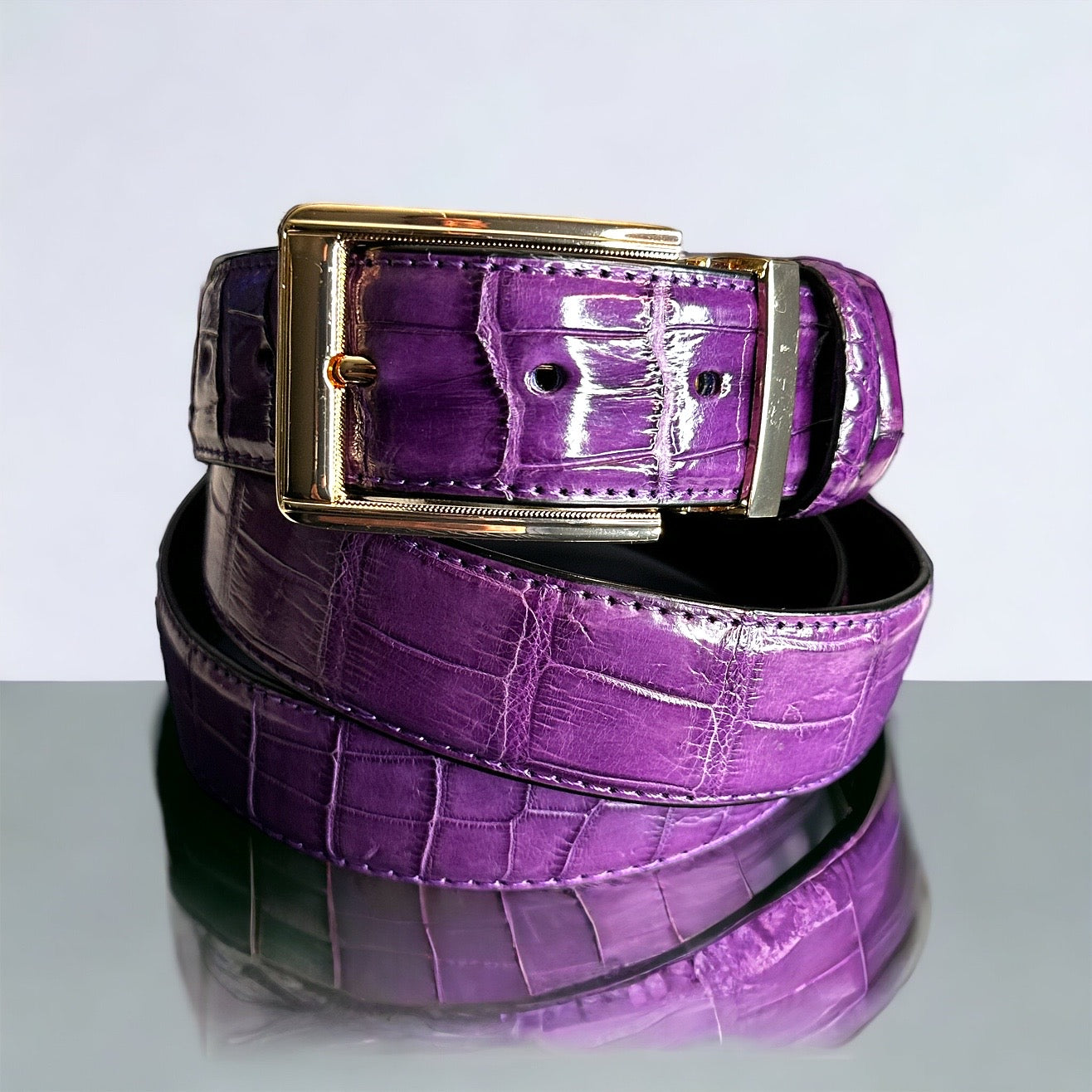 This handmade purple natural skin belt in crocodile serves as the standard for men's belts for suits. What is so great about this type of skin is that it fits with any outfit even jeans. With the supplied gold square and nickel square buckles, you get to choose what look you need for any type of event. Adjustable. 