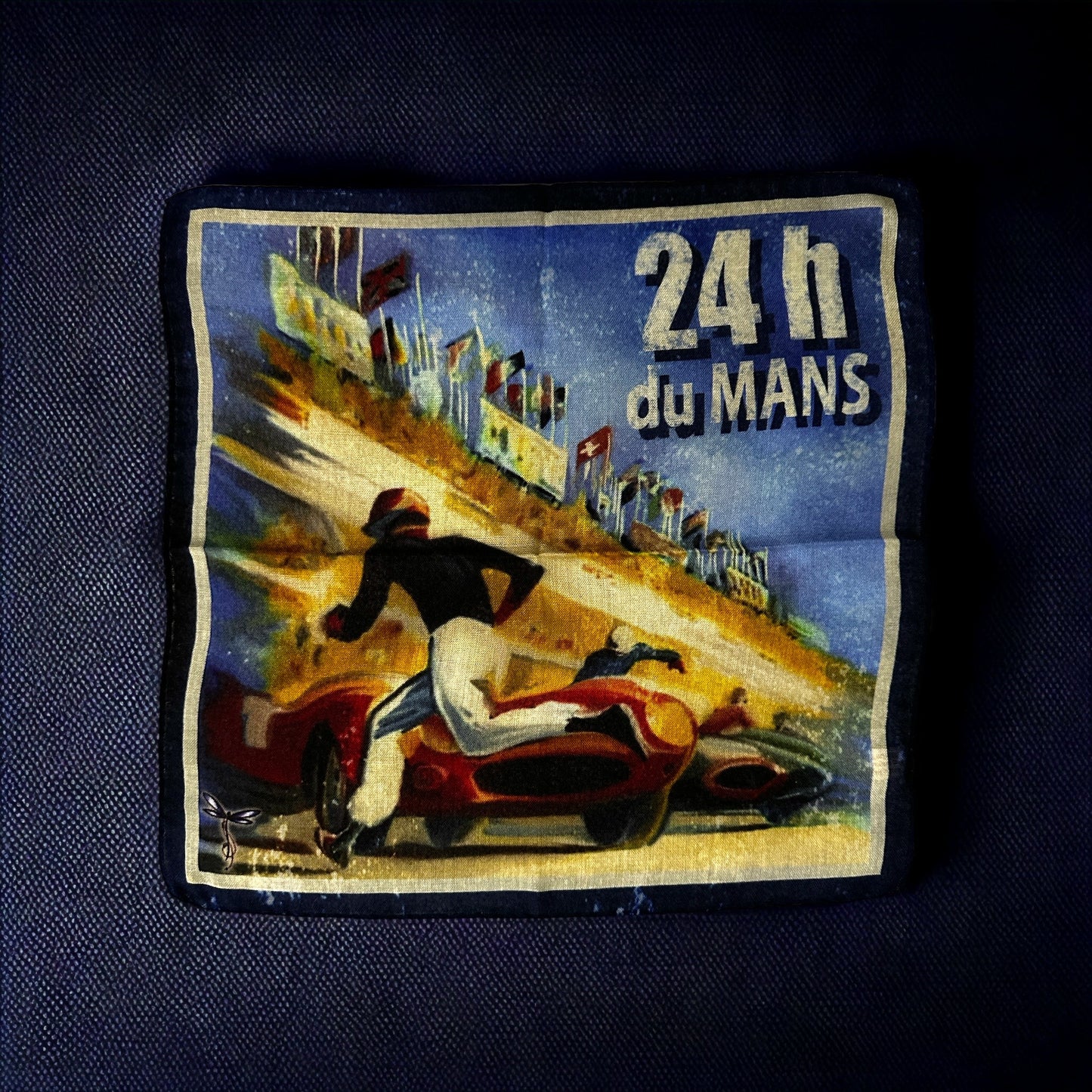 New designs in beautiful and colorful handkerchief for your new sport jacket or suit. Adding color and casualness to any outfit these pocket squares depict different exotic cities across the world. Here we have 24 hours of Le Mans auto race in France. Picturing the nostalgia of the race with the beginning of racing technology from the 1959 Grand Prix poster by Michel Beligord. Hand rolled edge. Made in Italy. 14 x14 inches.