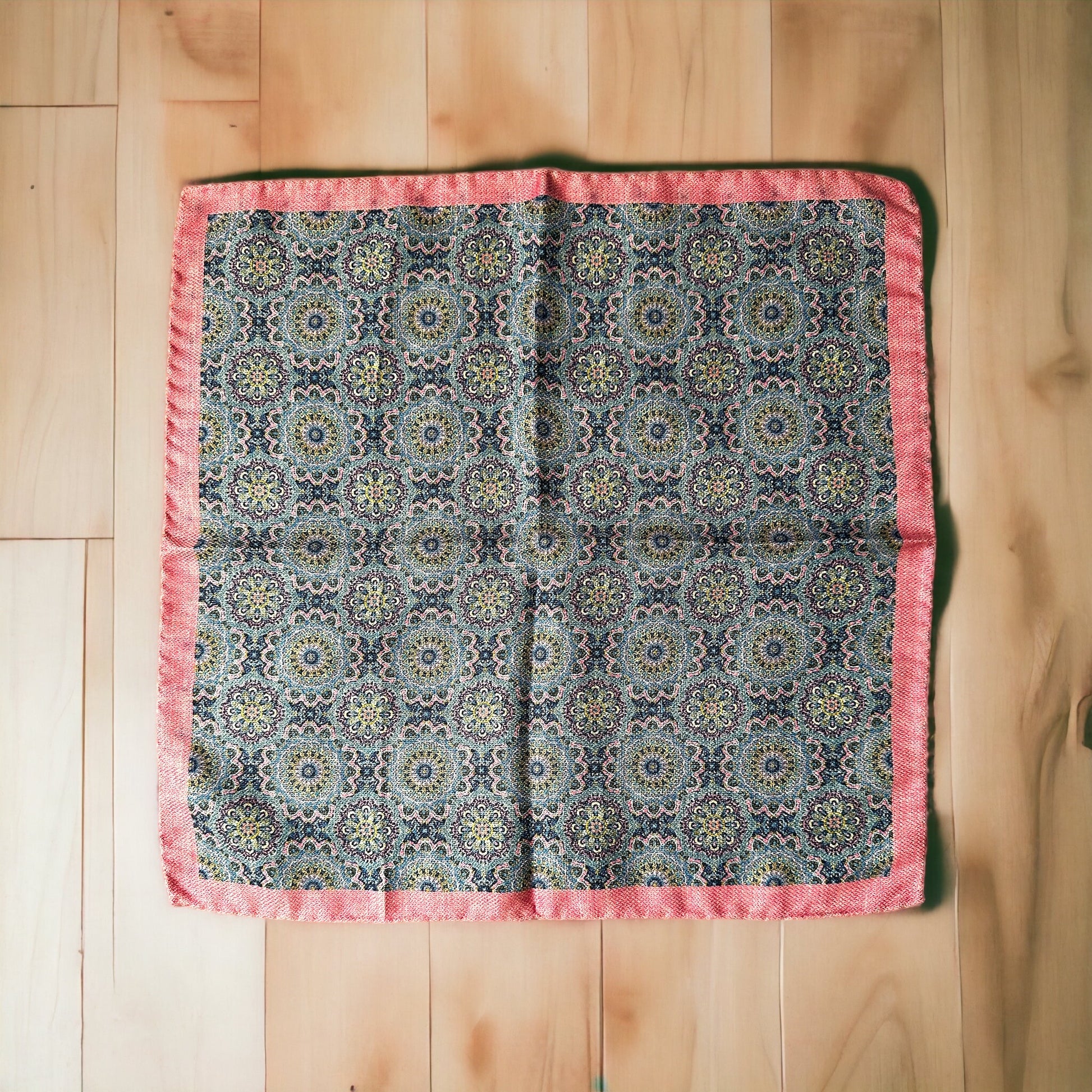 Hand rolled edges on this silk pocket square create gorgeous points that keep their position when using the breast pocket on a jacket. The pale pink and light blue circular pattern is a stunning classic all around geometric design. On the reverse is a different fun pattern of different colorful florets of blue on pink. A fun and playful pocket square for every occasion.