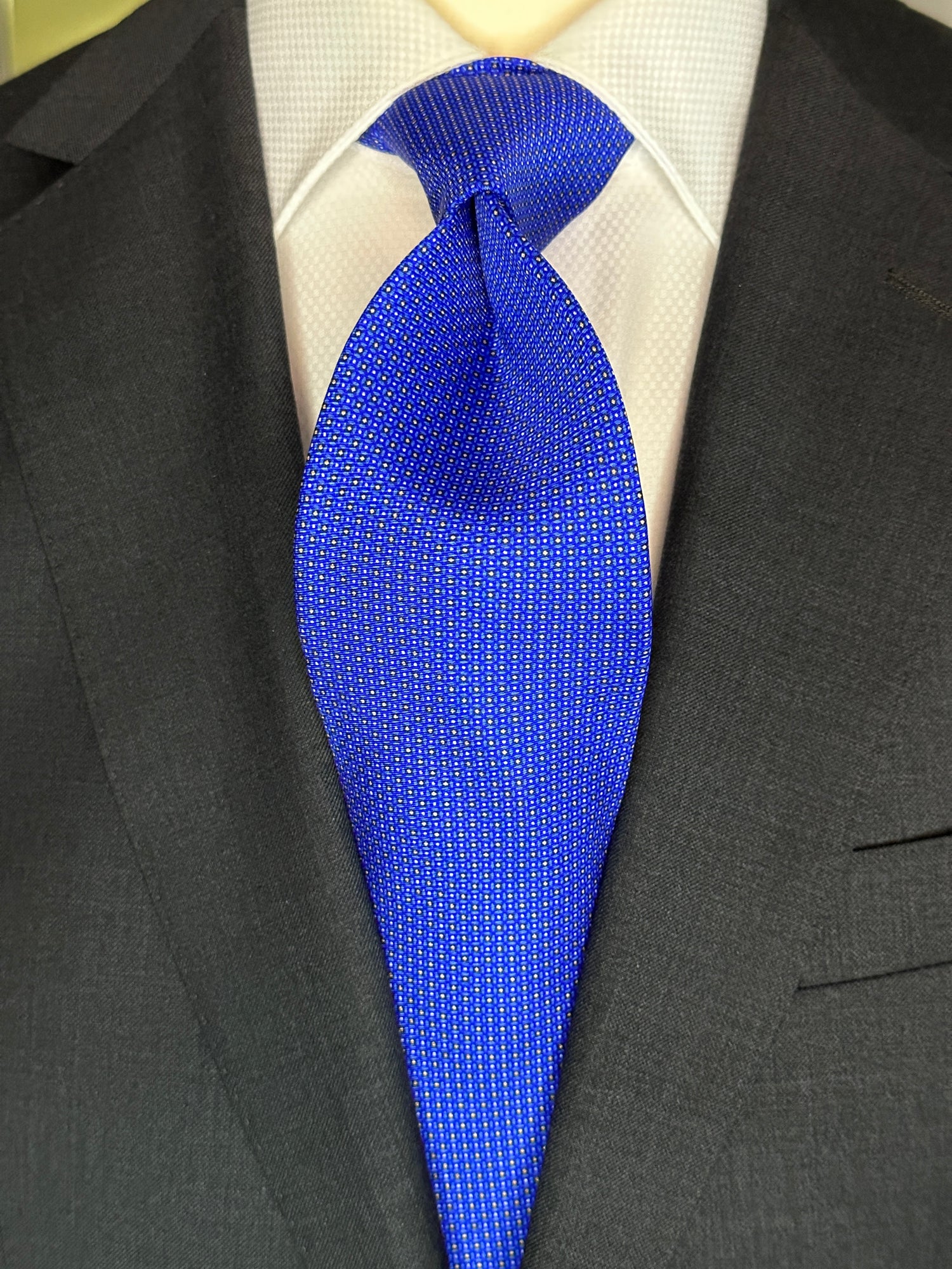 A beautiful bright vibrant blue silk twill tie with small geometric mini dots to create this semi solid fashion centric classic. Excellent with all shades of blue suits and great with linen in summer. 