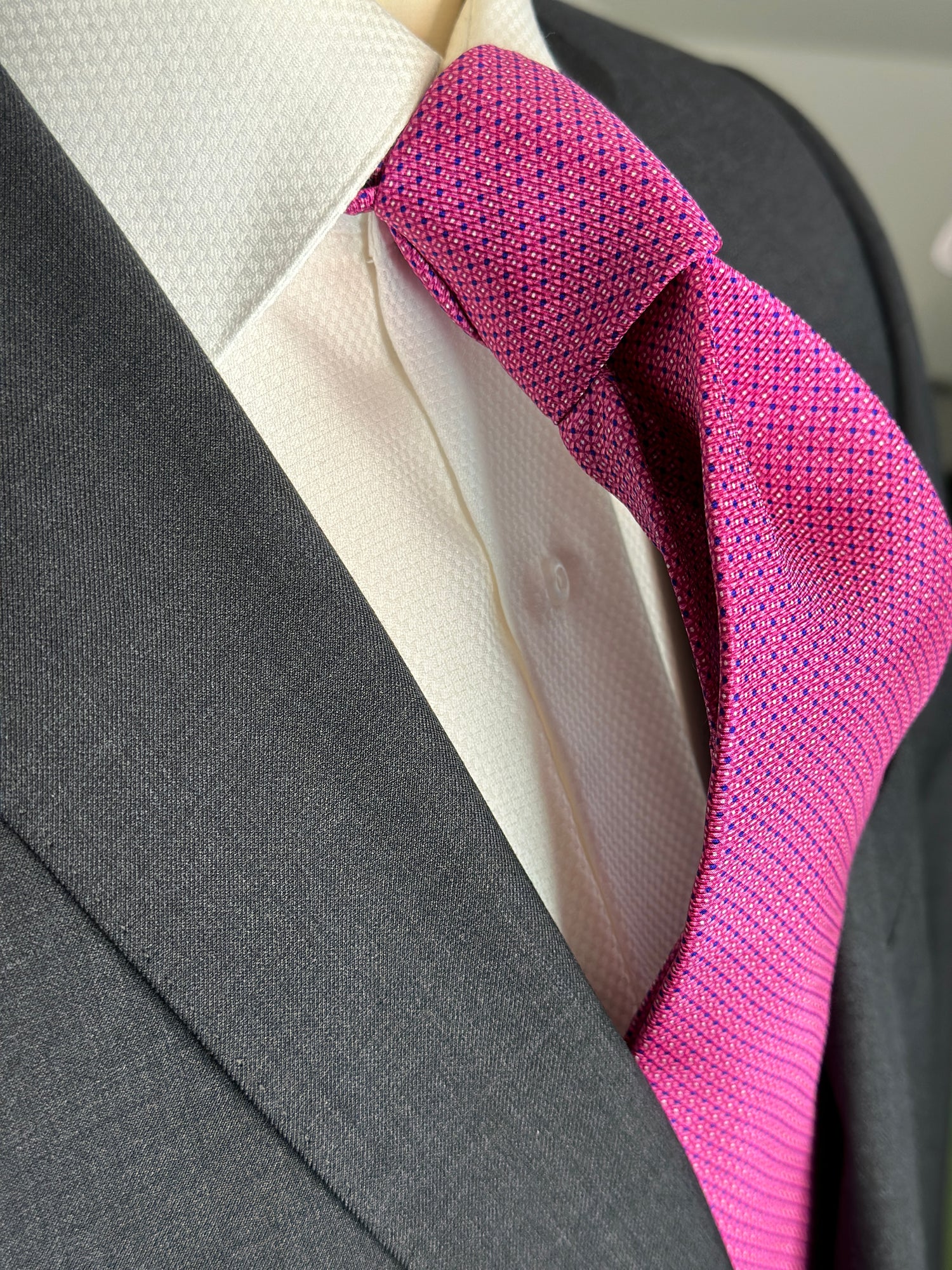 100% silk twill is a luxurious and rich silk. Smooth to the touch with a lightweight soft feel, this tie makes a striking statement in bright pink. It does, however, become toned down due to its very neat and small mini dot geometric pattern. Great for everyday business or law this tie goes out day and night.