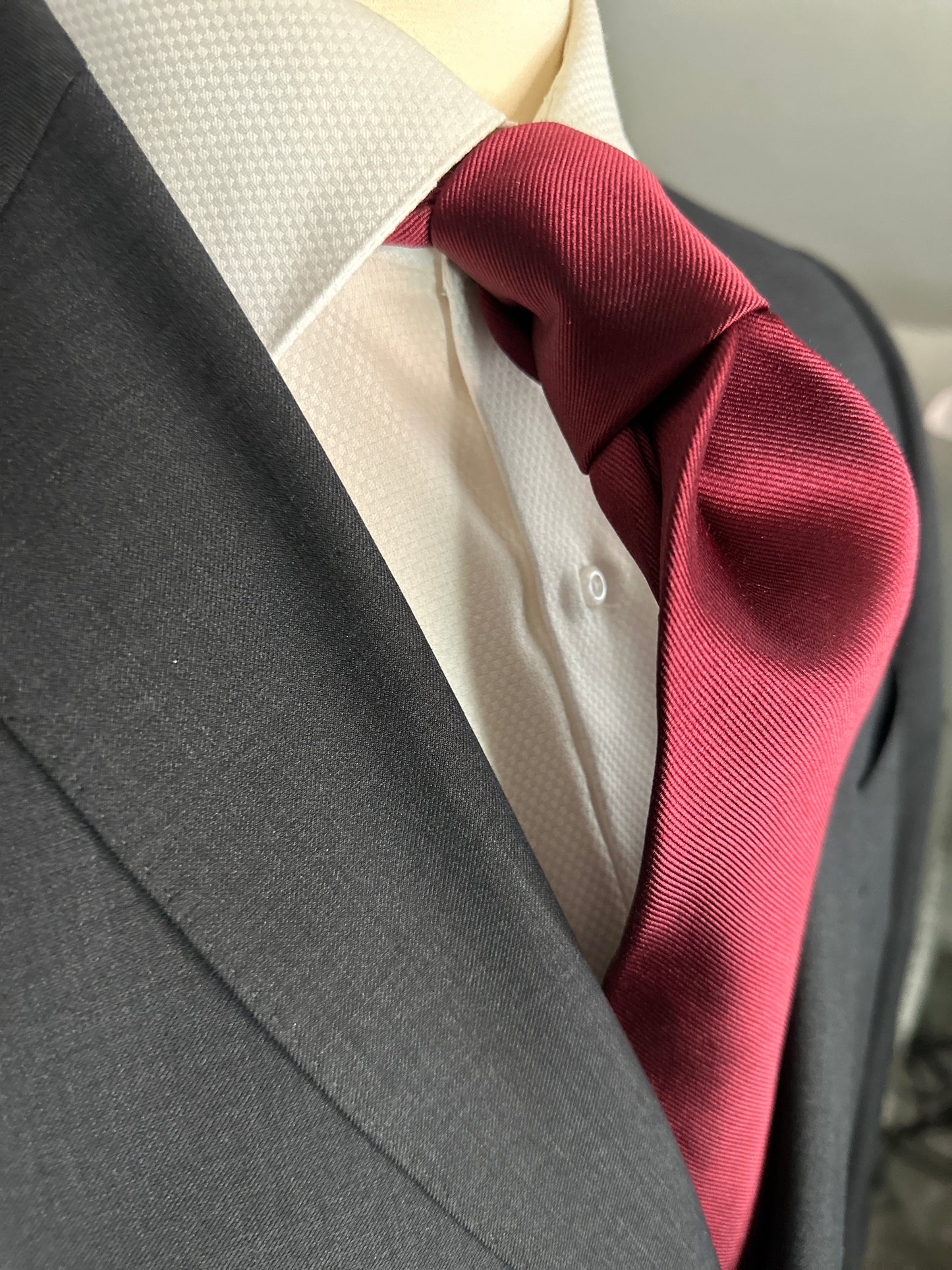 Solid ties are beautifully paired with the more busy of patters of bold stripes and heavy plaids. However, there is something so understated and elegant about a solid tie with a solid suit. Whether that be navy, charcoal or black a burgundy tie fits well with a white shirt and even a navy blazer with jeans.