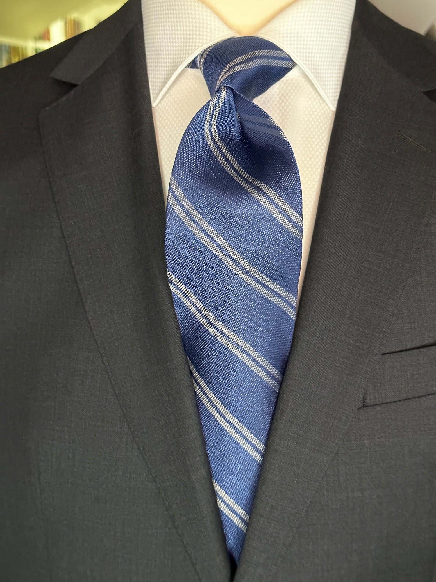 The textured woven silk of this blue denim tie is perfect for all seasons. The texture goes well with wool flannels, plaids and interesting mini checks. Made from 100% silk, the denim blue necktie combines well with pure white for that contrast or a pale grey to bring out the double charcoal stripe in the tie.