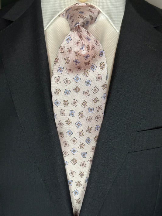 A 100% silk tie in pastel pink that has the characteristics and feel of linen. For those light weight summer outfits and thin cotton summer dress shirts, including Swiss voile, you need a tie that carries the same type of personality. The weave of this silk looks like the weave of pure linen, but has the smooth feel of silk. 