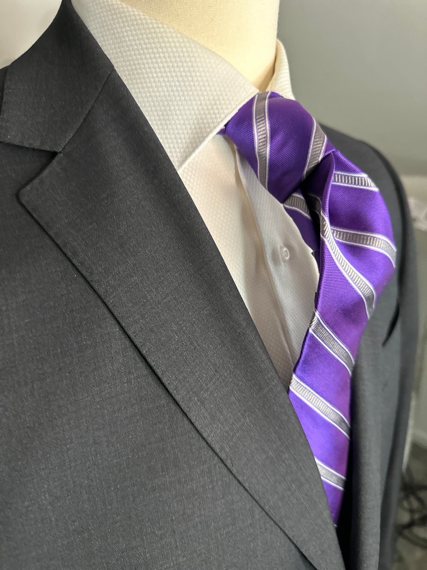 This beautiful deep purple woven silk tie with stone grey stripe pairs perfectly with a soft charcoal grey suit or navy pinstripe. For summer it would also go well with the classic tan summer suit. Try it with a navy blazer and pale grey trousers for a mid afternoon summer look.