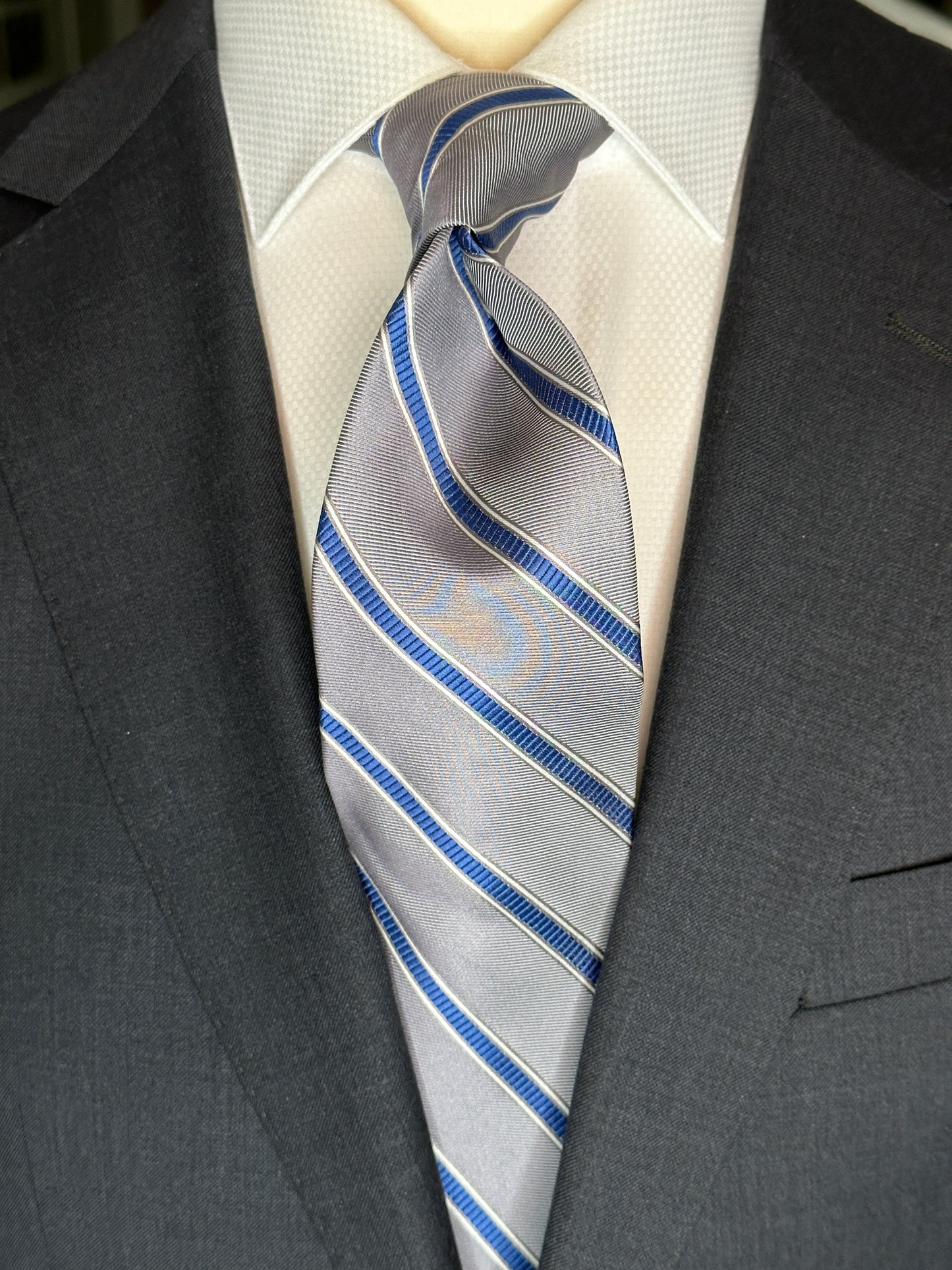 This 100% woven silk tie is a perfect stone grey. Allowing for matching with many colors, the stone grey is very neutral in its base. Added is a touch of french blue stripe. Just enough to bring out the blue in any garment or shirt. 