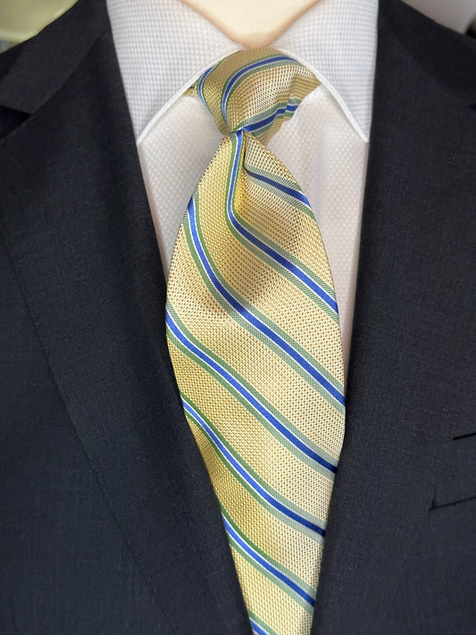 A general all around great tie to wear with any suit, shirt for any occasion. With two different types of silk in the same necktie, the stripe being satin and the broad section being woven, this tie makes an all day knot that does not have to be readjusted. With colorations of kelly green and blue stripes, you cannot make a mistake creating a look with this tie pairing with any suit in your closet.