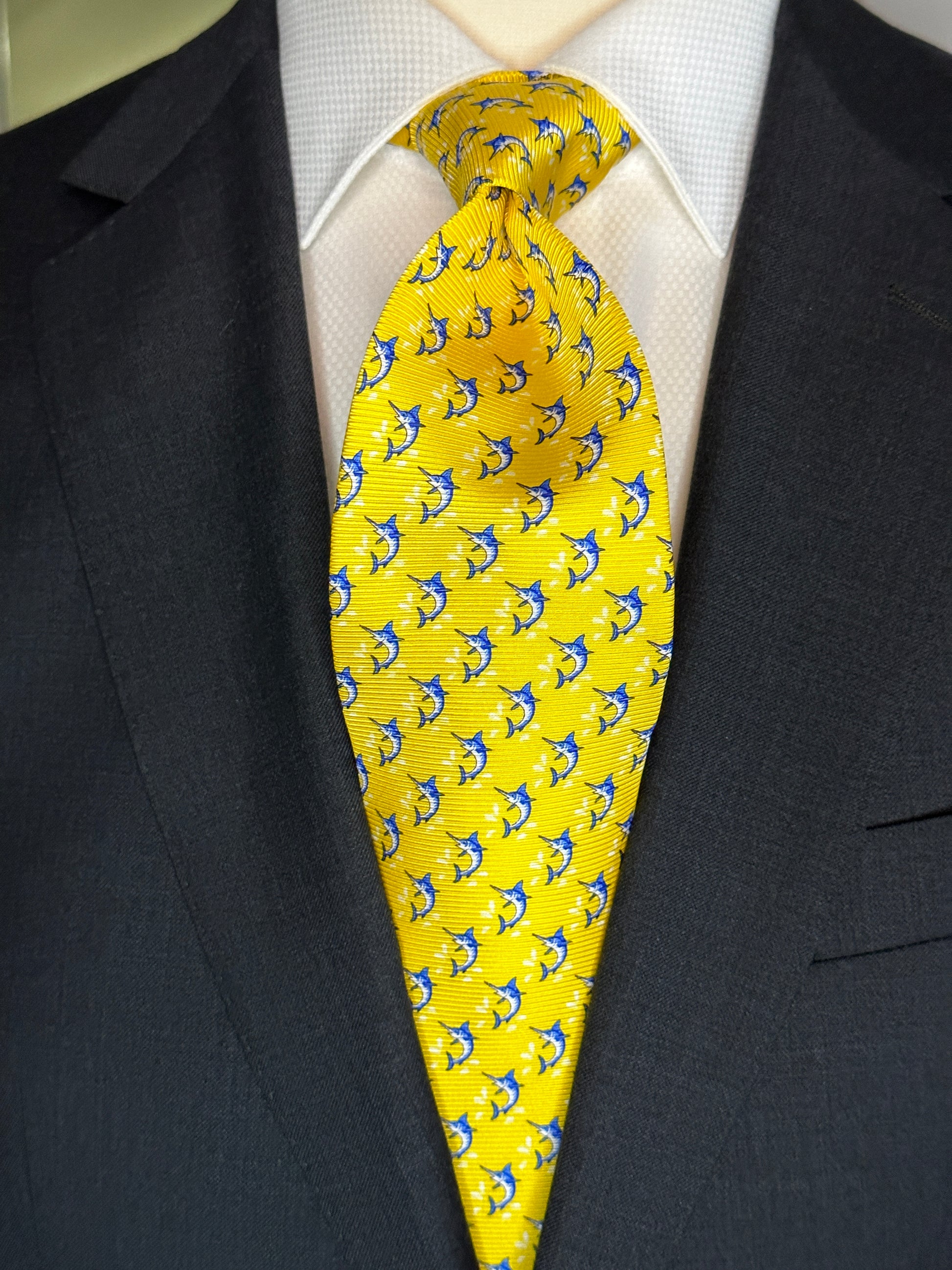 This beautiful 100% silk twill necktie features the swordfish motif with small splashes of water. Being a geometric type pattern, this tie is most interesting because people tend to look twice to realize that the pattern is made up of blue swordfish. Hermes style..